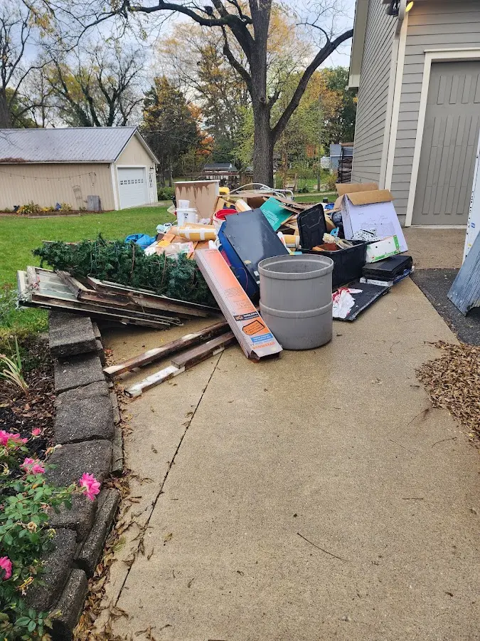 Dumpster being loaded with debris for 12 Yard Dumpster Rental in California